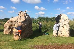 Children climbing boulders at RSPB Rainham Marshes